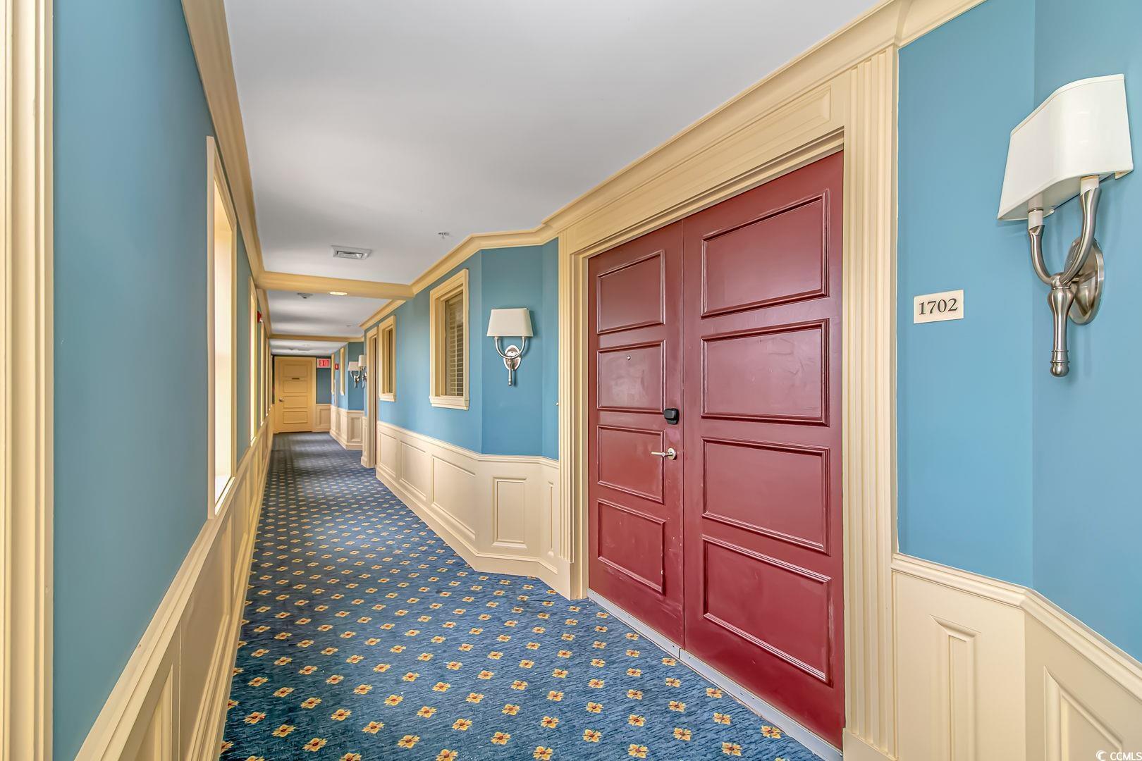 Image 2: Hallway featuring carpet, a wainscoted wall, and v Image 2: Hallway featuring carpet, a wainscoted wall, and v
