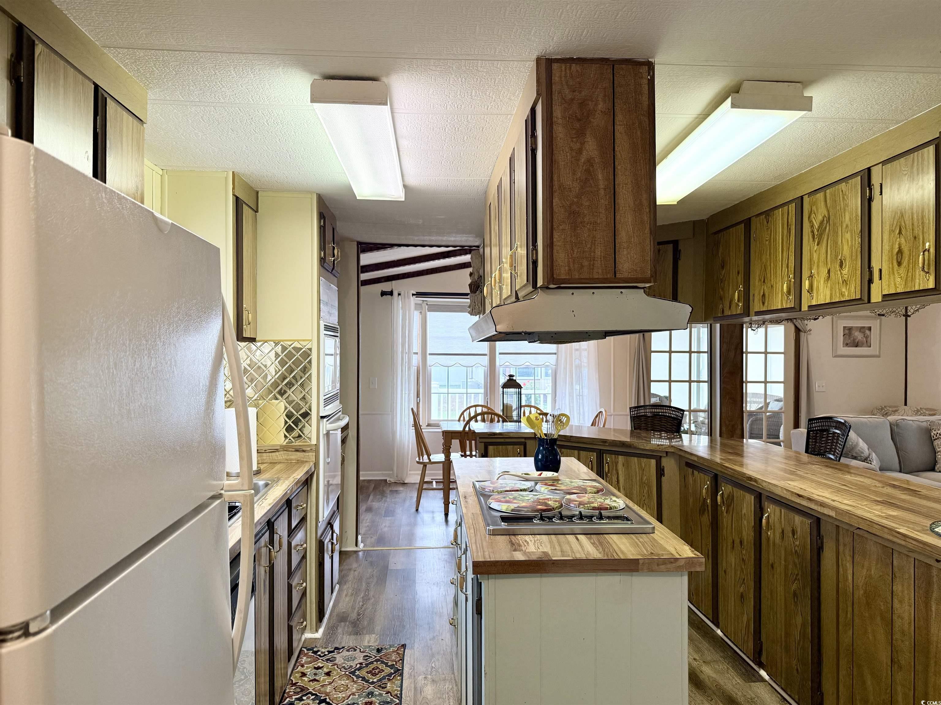 Image 2: Kitchen featuring butcher block countertops, frees