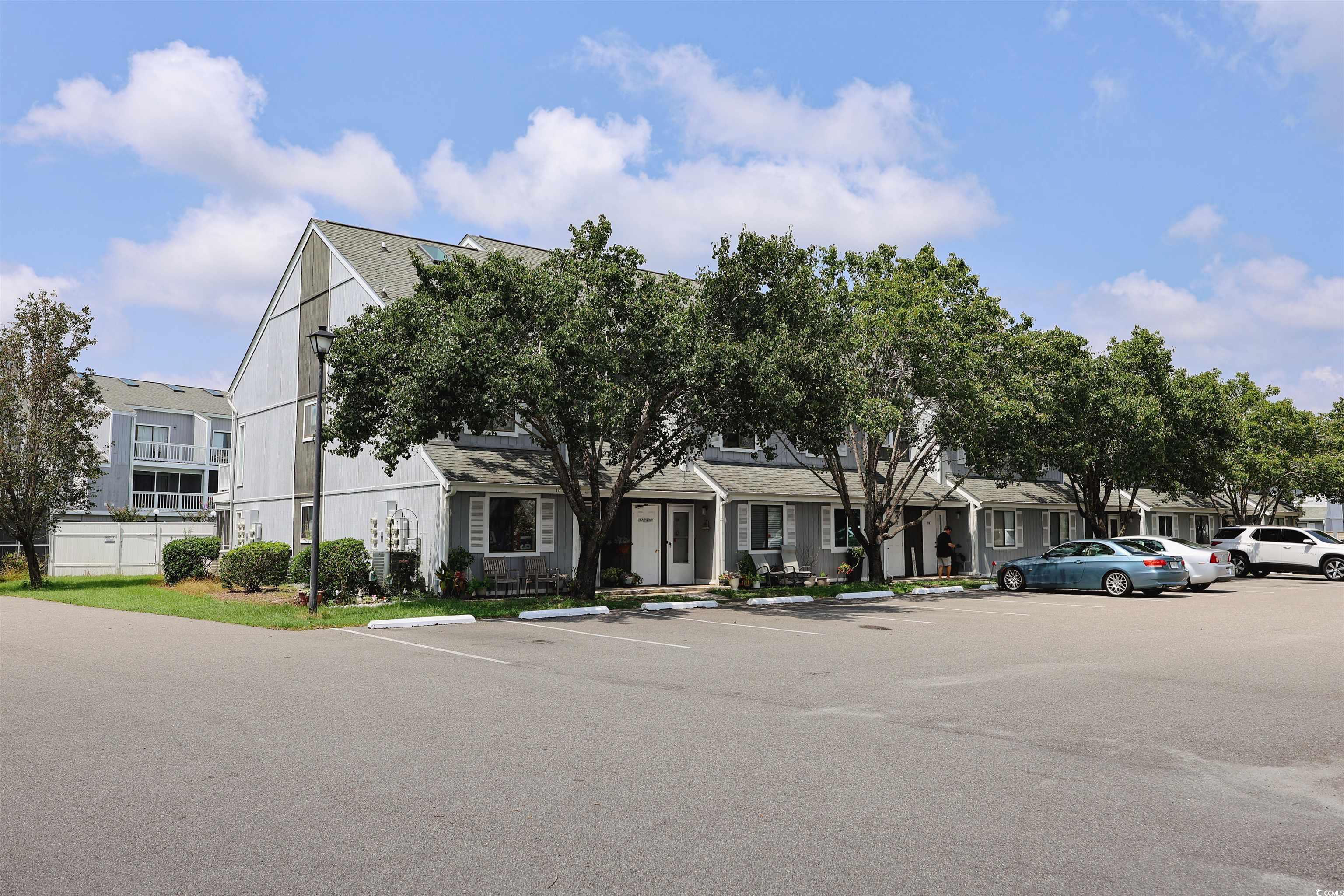 Image 1: View of front of property with uncovered parking a