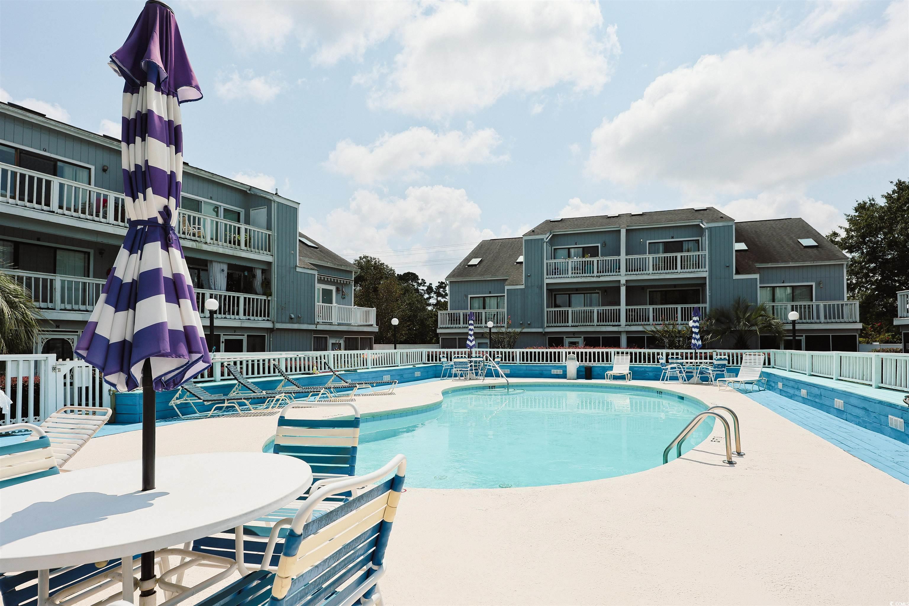 Image 3: Community pool featuring a patio