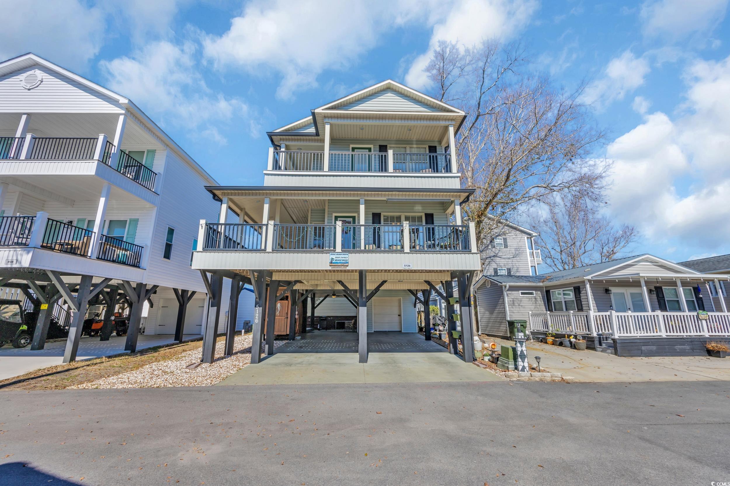 Image 2: Raised beach house featuring a carport Image 2: Raised beach house featuring a carport