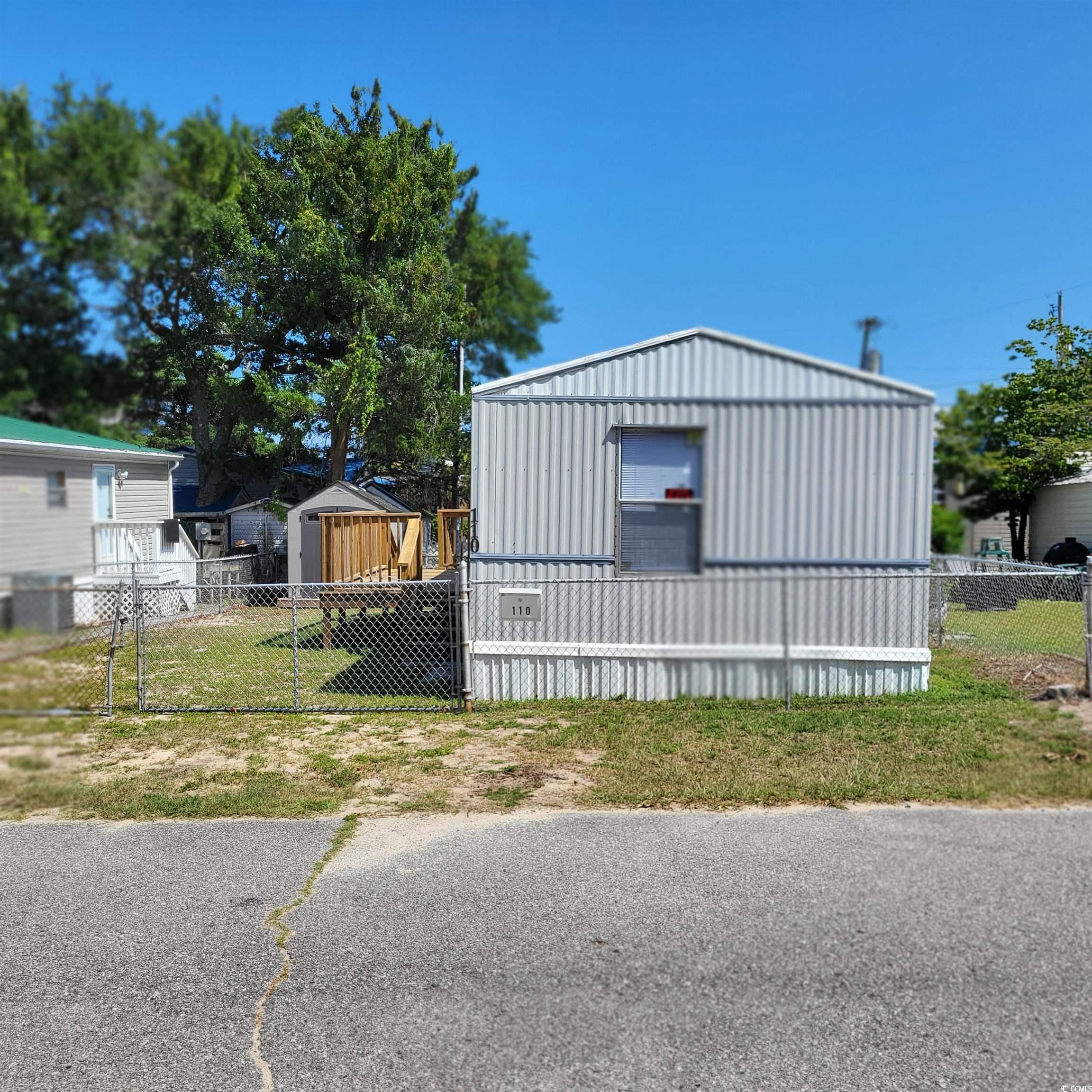 Image 1: View of side of home featuring an outbuilding and