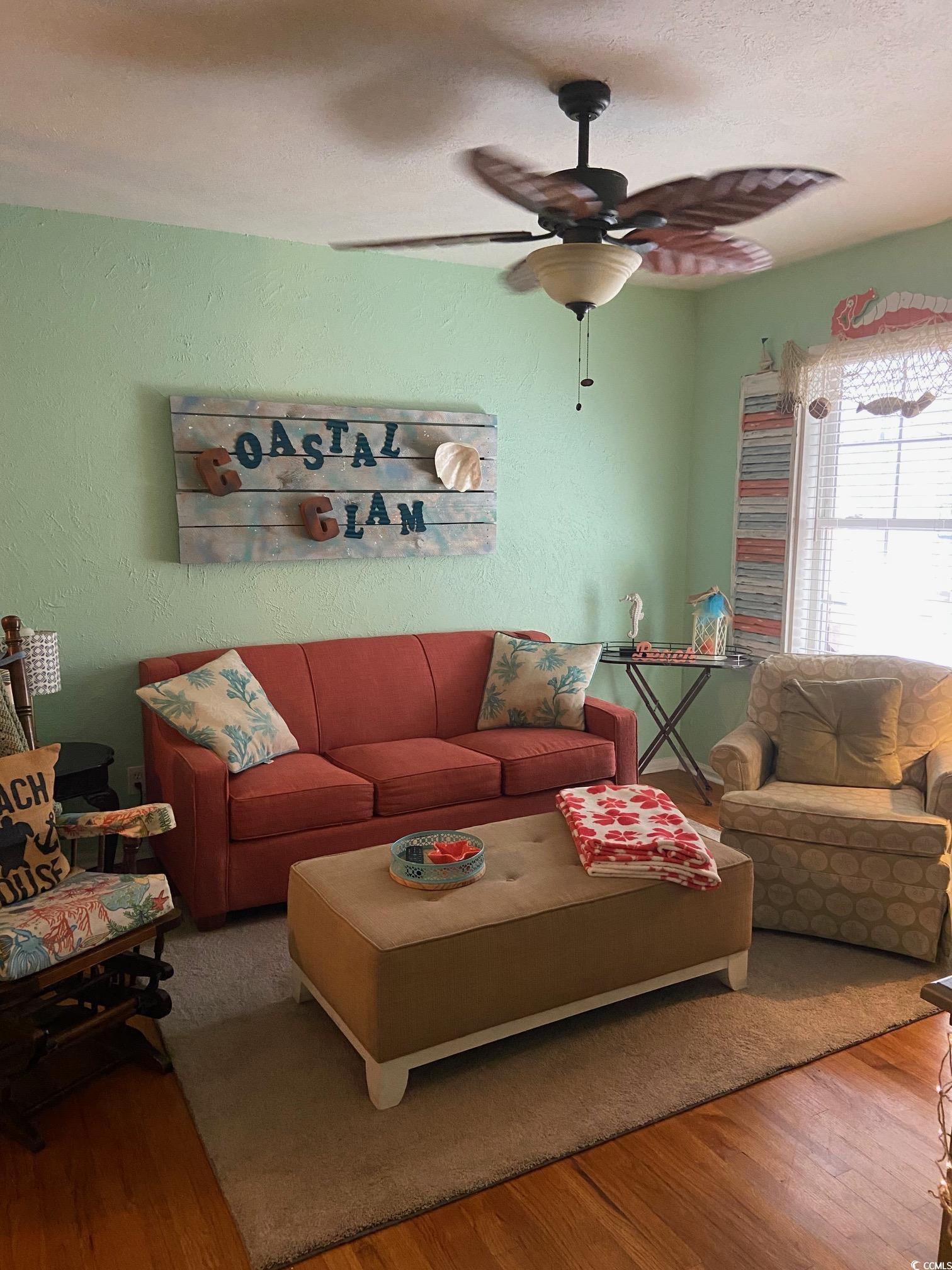 Image 4: Living area with hardwood / wood-style floors, a t