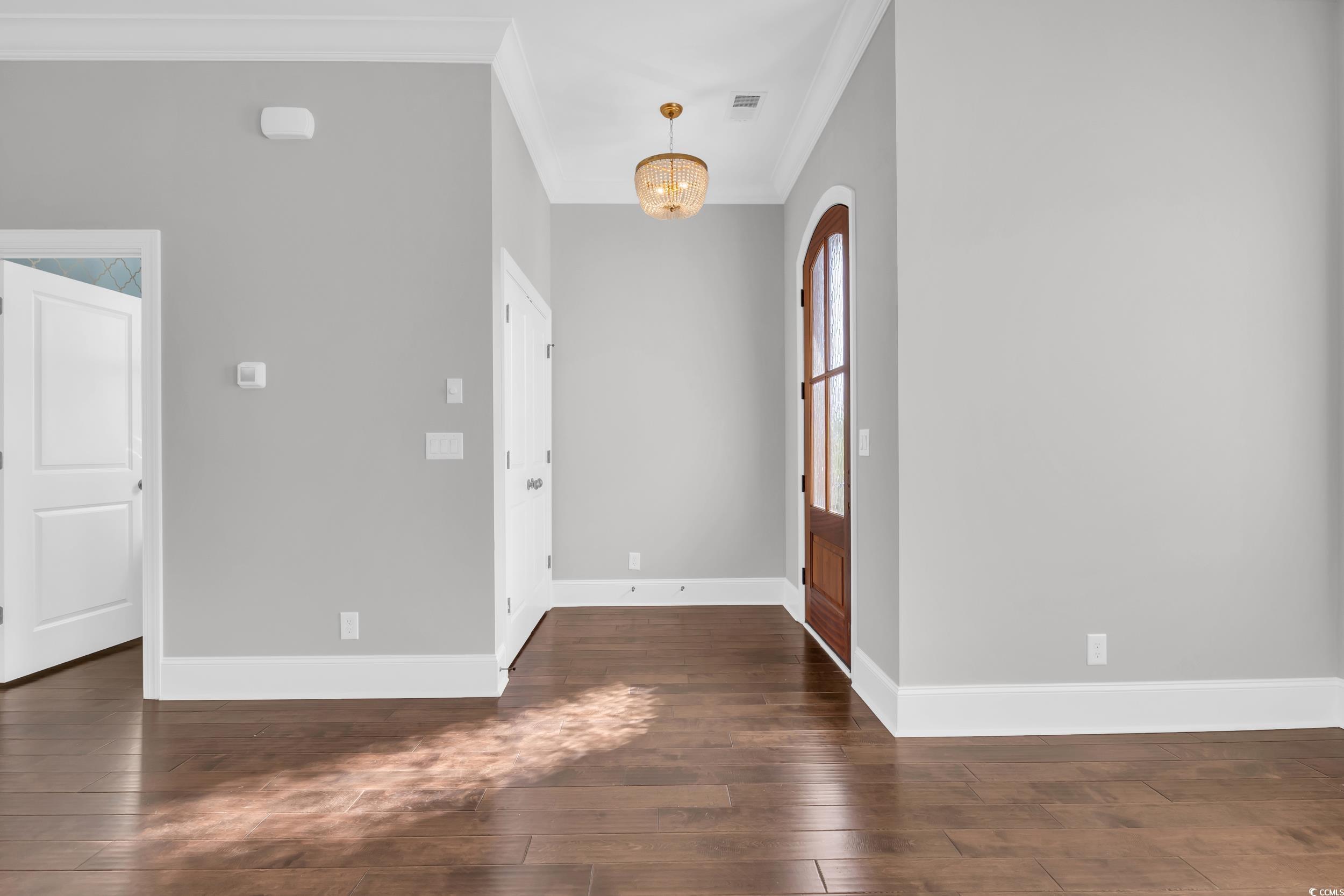 Image 4: Foyer featuring crown molding, dark wood-style flo Image 4: Foyer featuring crown molding, dark wood-style flo