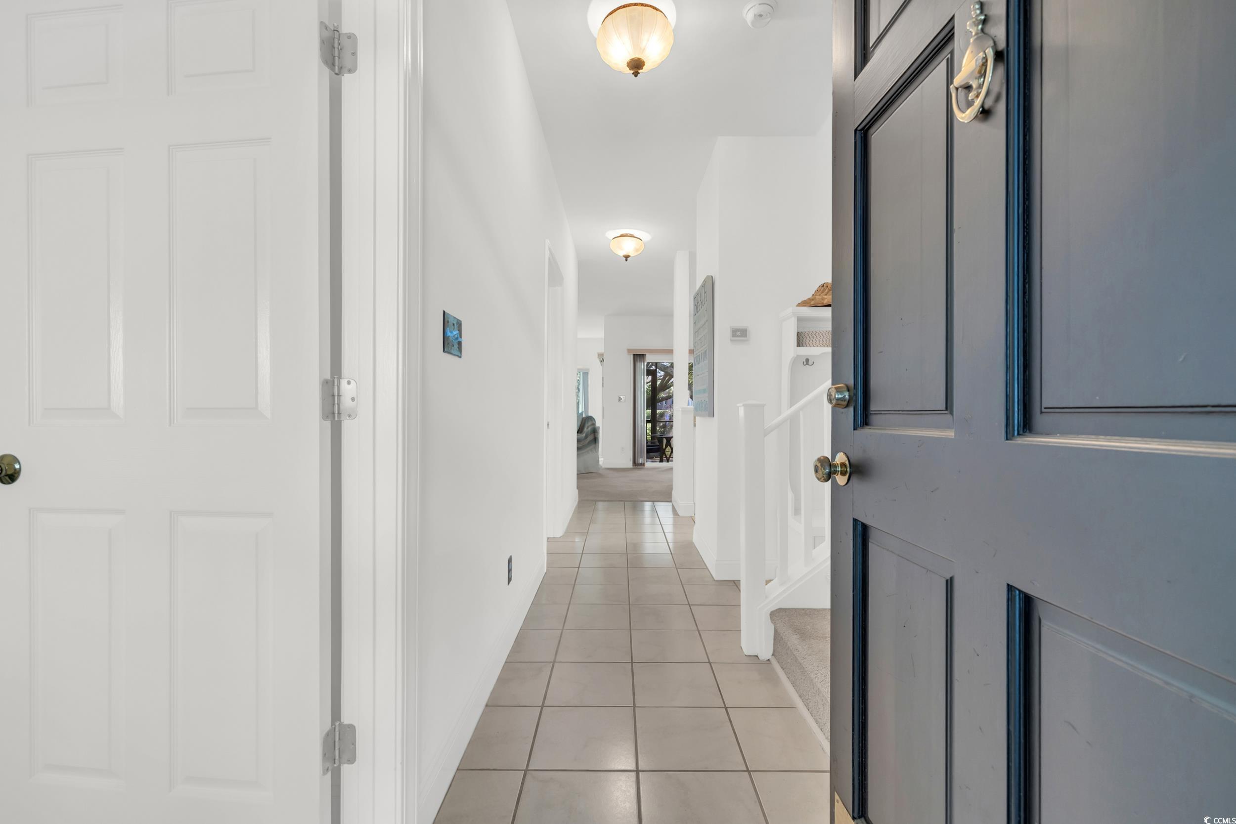 Image 3: Hallway with light tile patterned floors and stair Image 3: Hallway with light tile patterned floors and stair