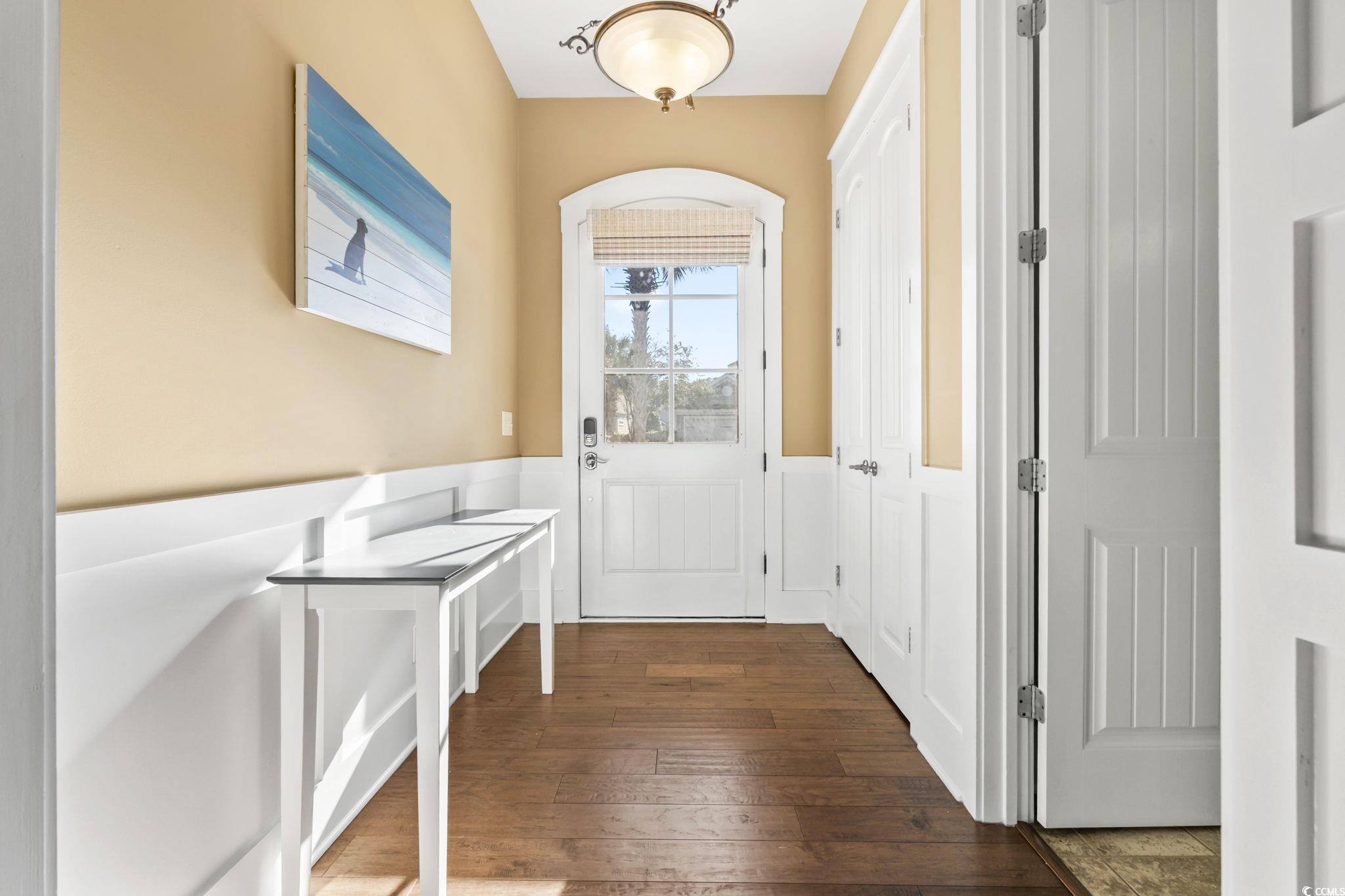 Image 3: Entryway featuring wood-type flooring and wainscot Image 3: Entryway featuring wood-type flooring and wainscot