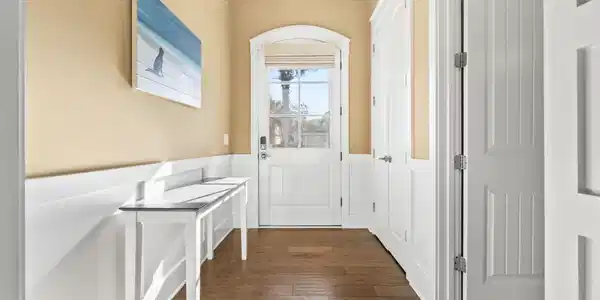 Image 3: Entryway featuring wood-type flooring and wainscot Image 3: Entryway featuring wood-type flooring and wainscot