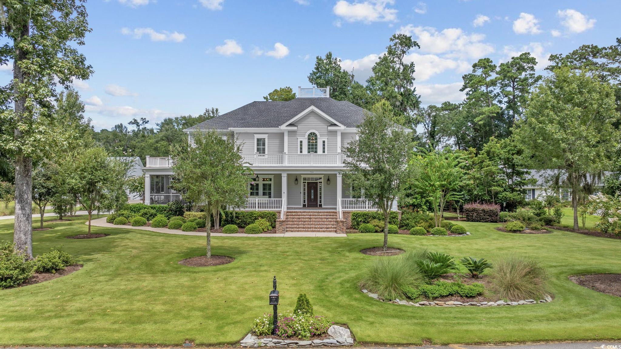 Image 3: View of front facade with covered porch, a front l