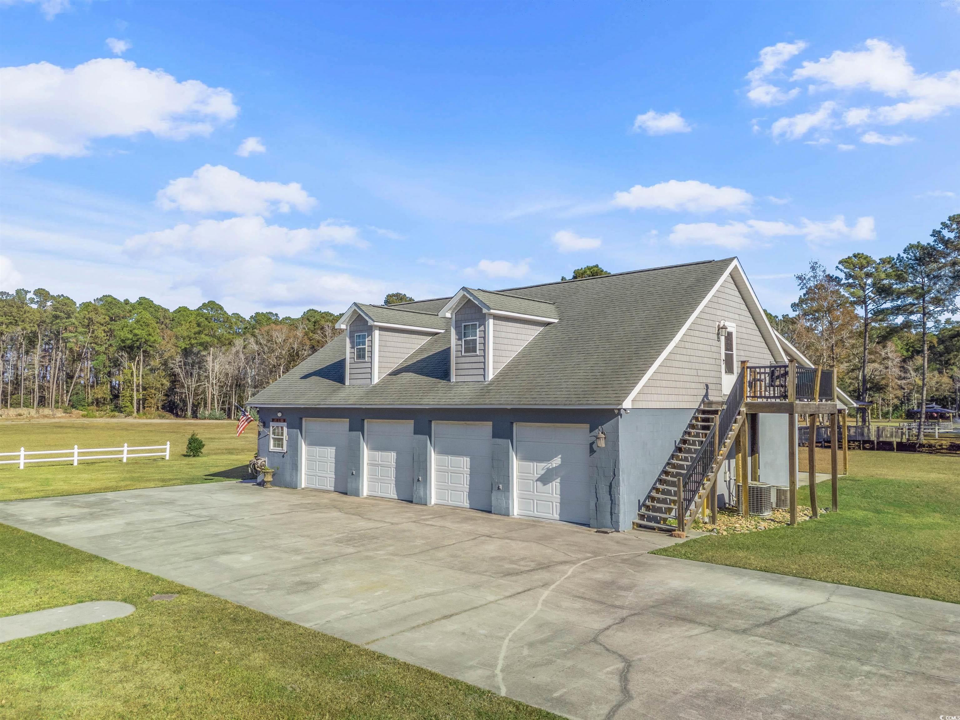Image 3: View of side of home featuring concrete driveway a
