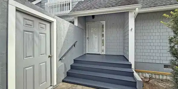 Image 2: Entrance to property featuring a shingled roof
