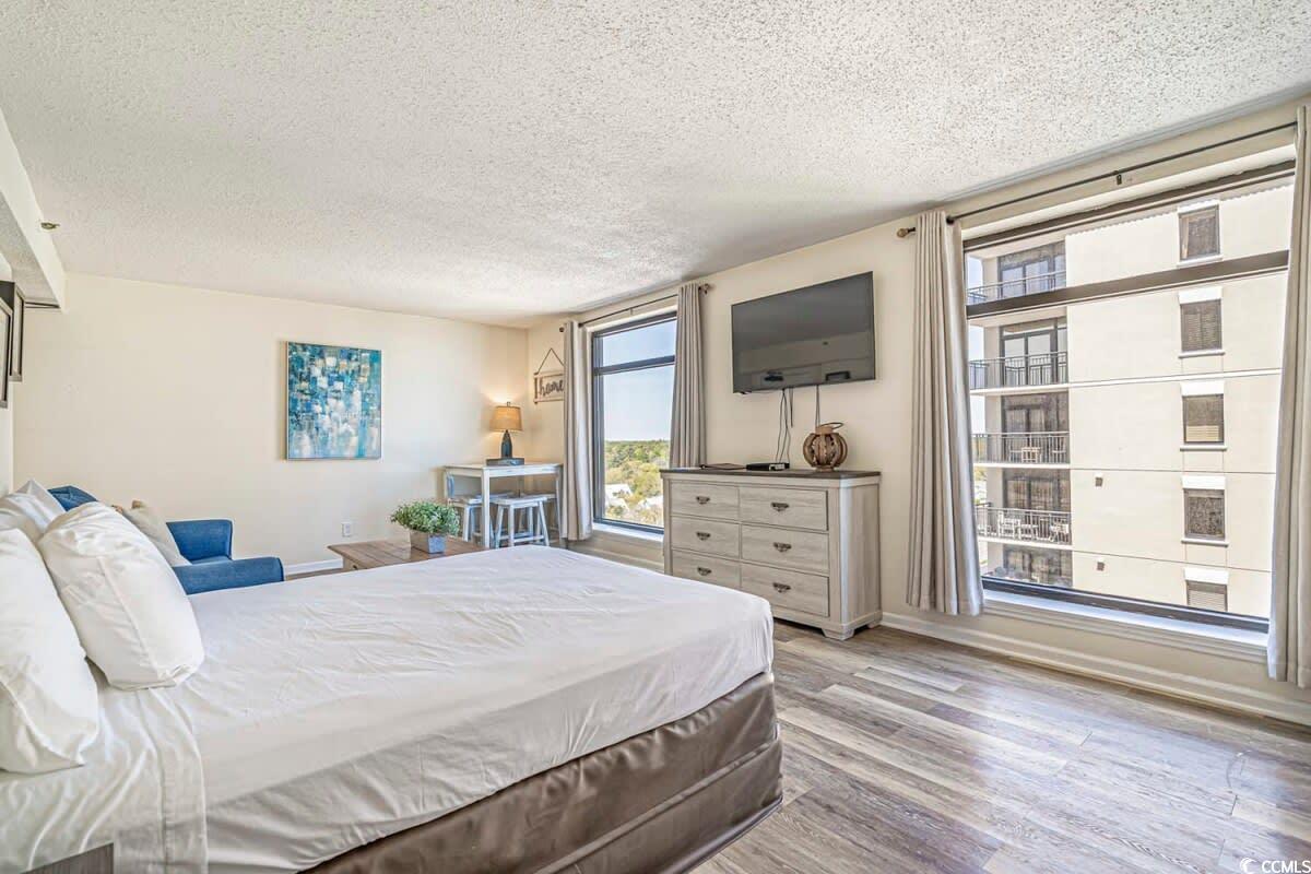Image 3: Bedroom featuring baseboards, a textured ceiling,