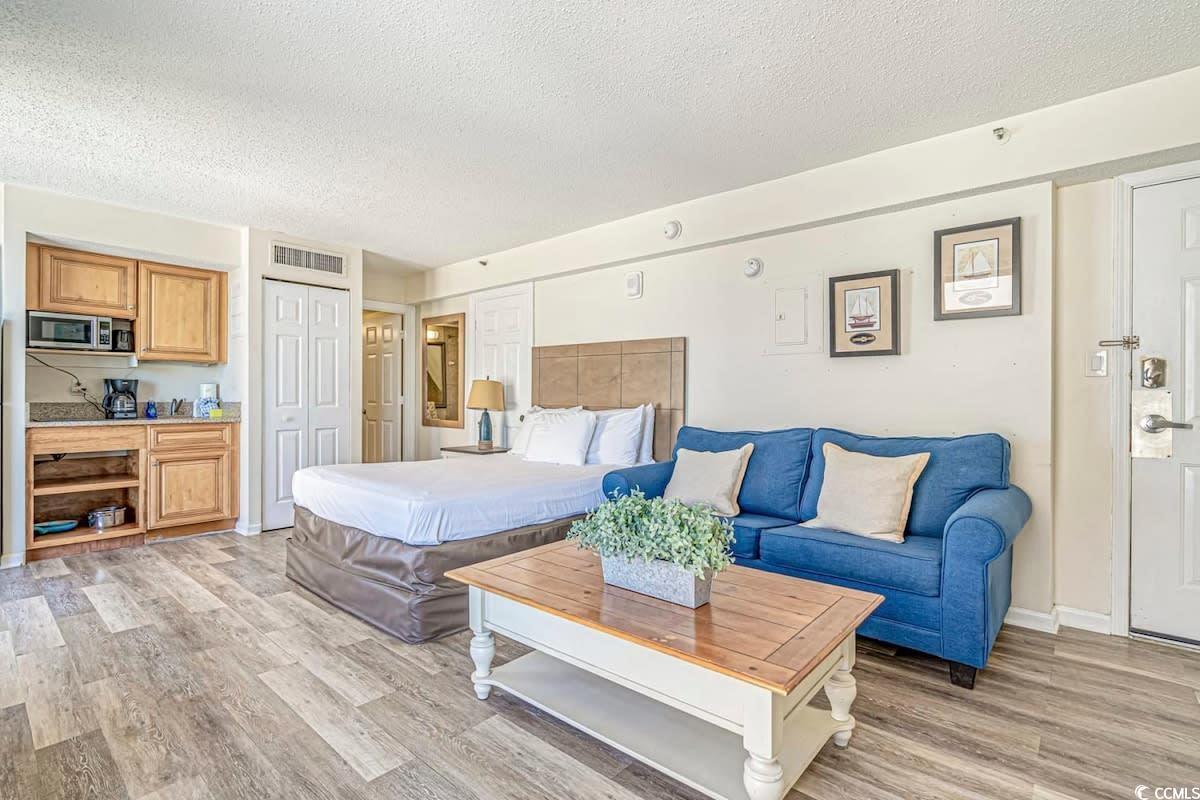 Image 4: Bedroom featuring visible vents, light wood-style