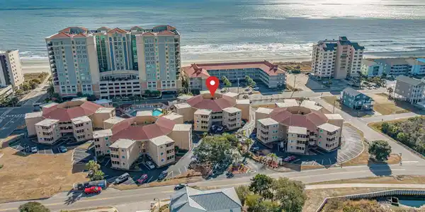 Image 2: Drone / aerial view with a water view and a beach