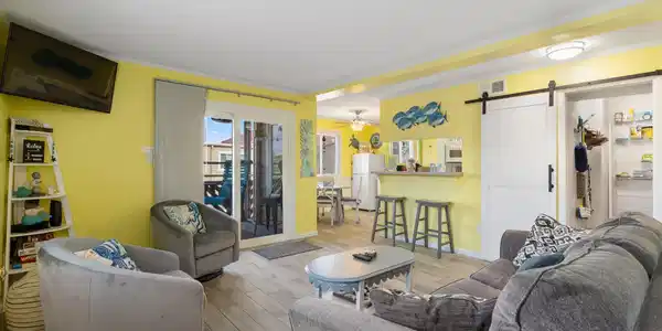 Image 4: Living room with a barn door, ceiling fan, light h