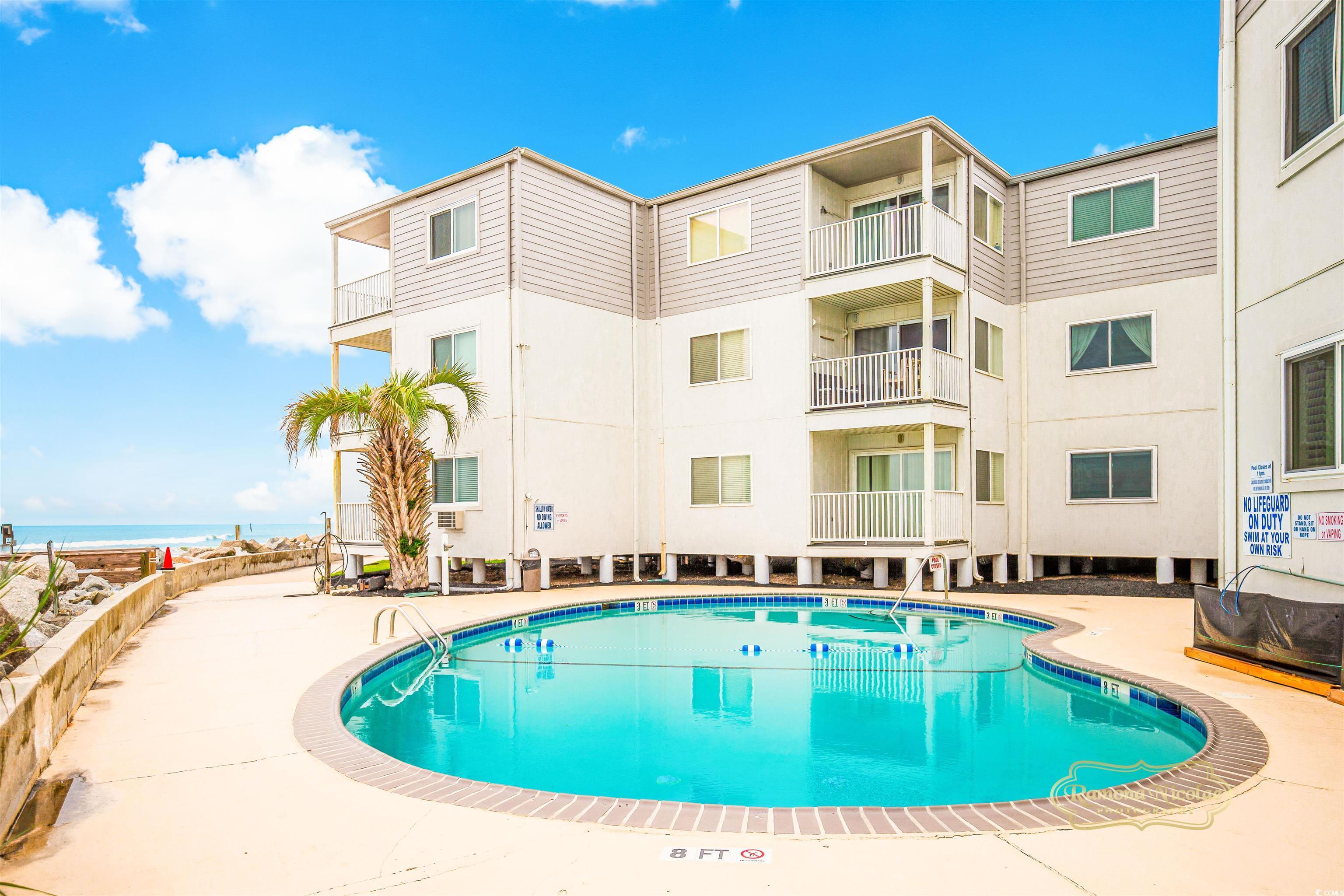 Image 2: Community pool with a patio Image 2: Community pool with a patio