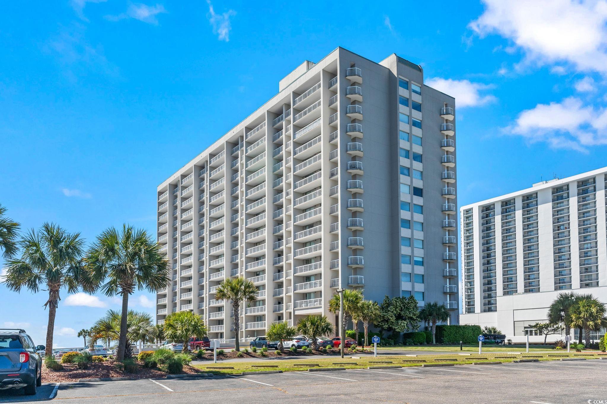Image 1: View of building exterior with uncovered parking Image 1: View of building exterior with uncovered parking