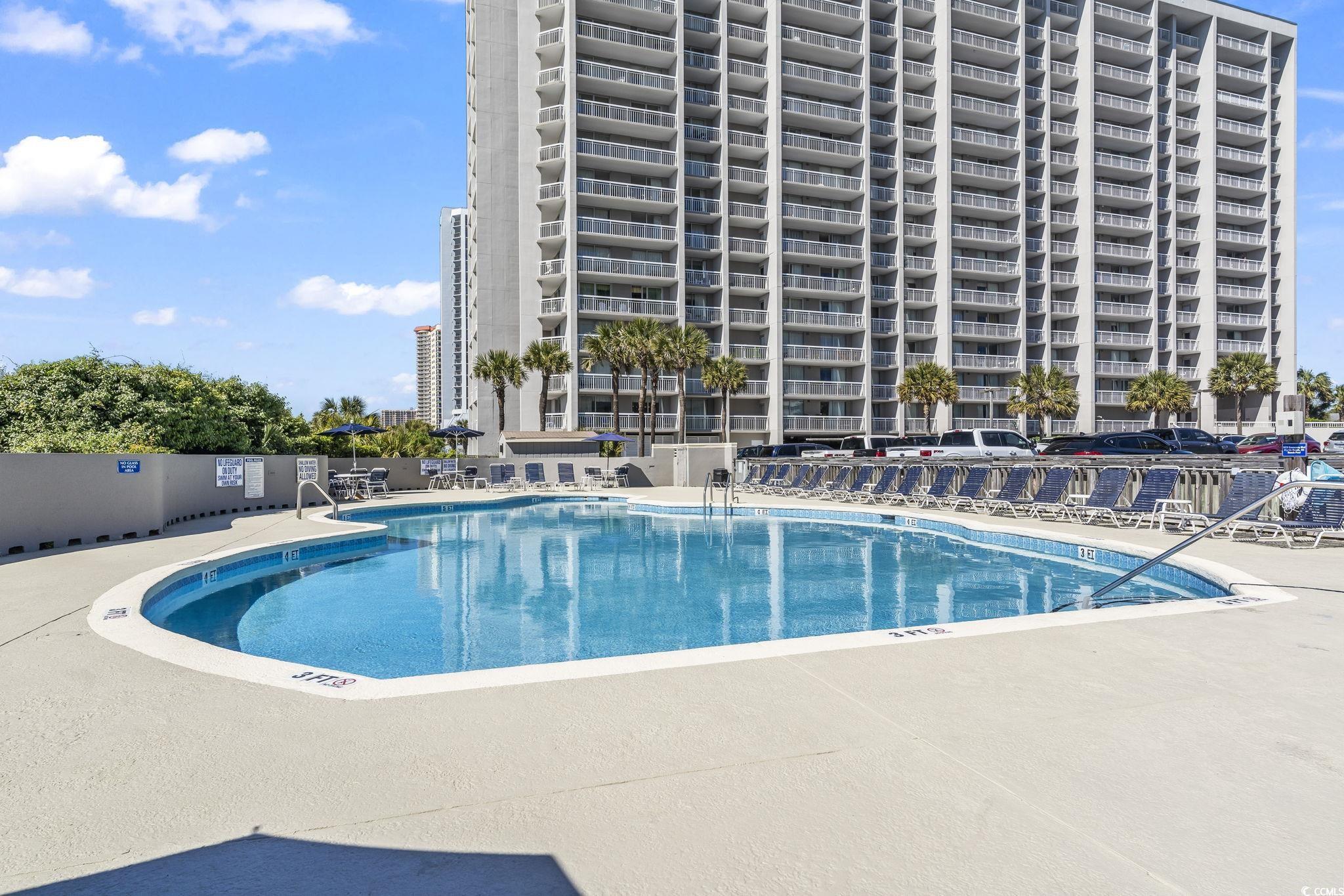 Image 4: Community pool with a patio Image 4: Community pool with a patio