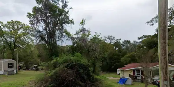 Image 4: View of green lawn featuring a deck
