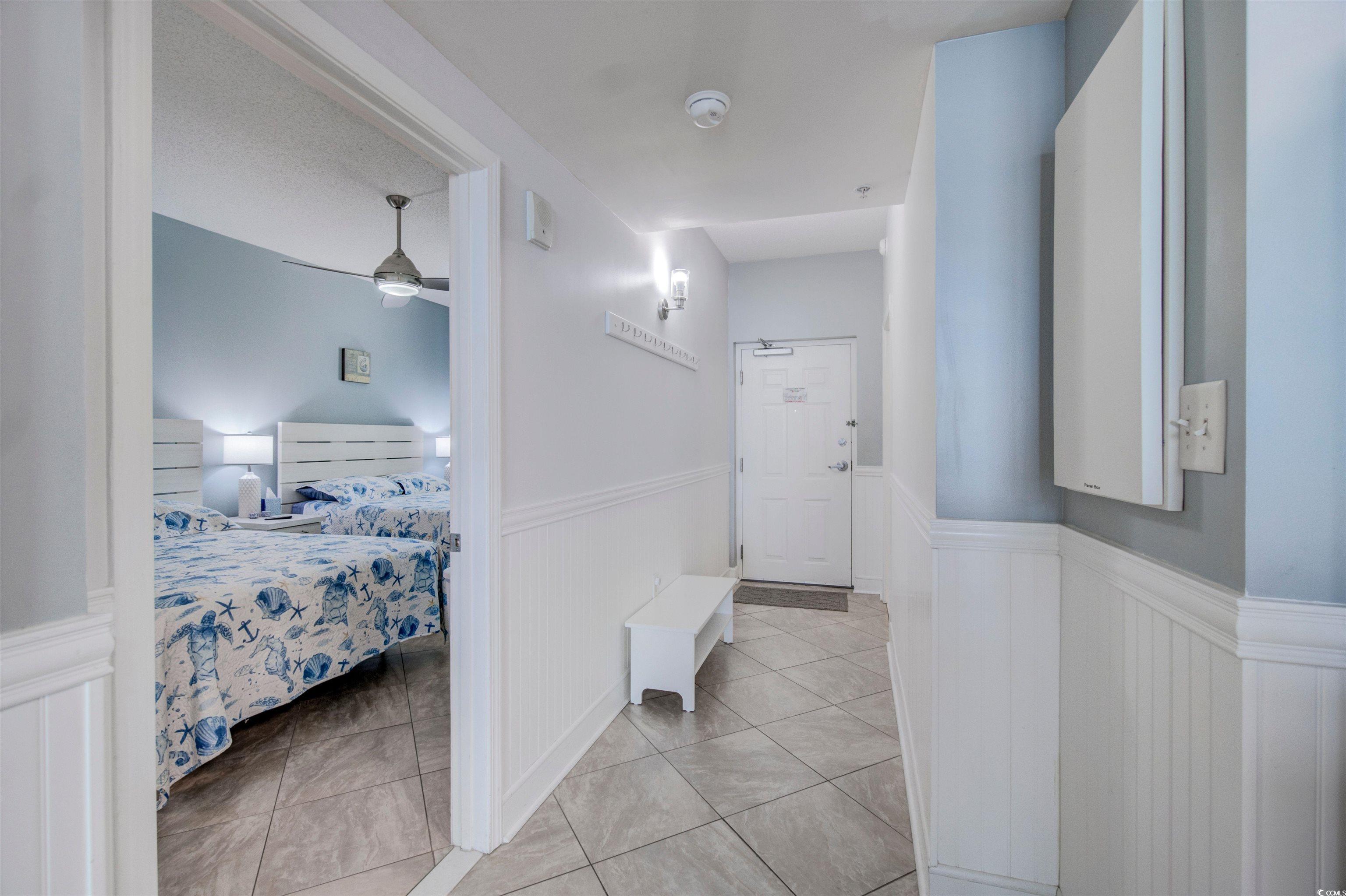 Image 2: Hallway featuring wainscoting, light tile patterne Image 2: Hallway featuring wainscoting, light tile patterne