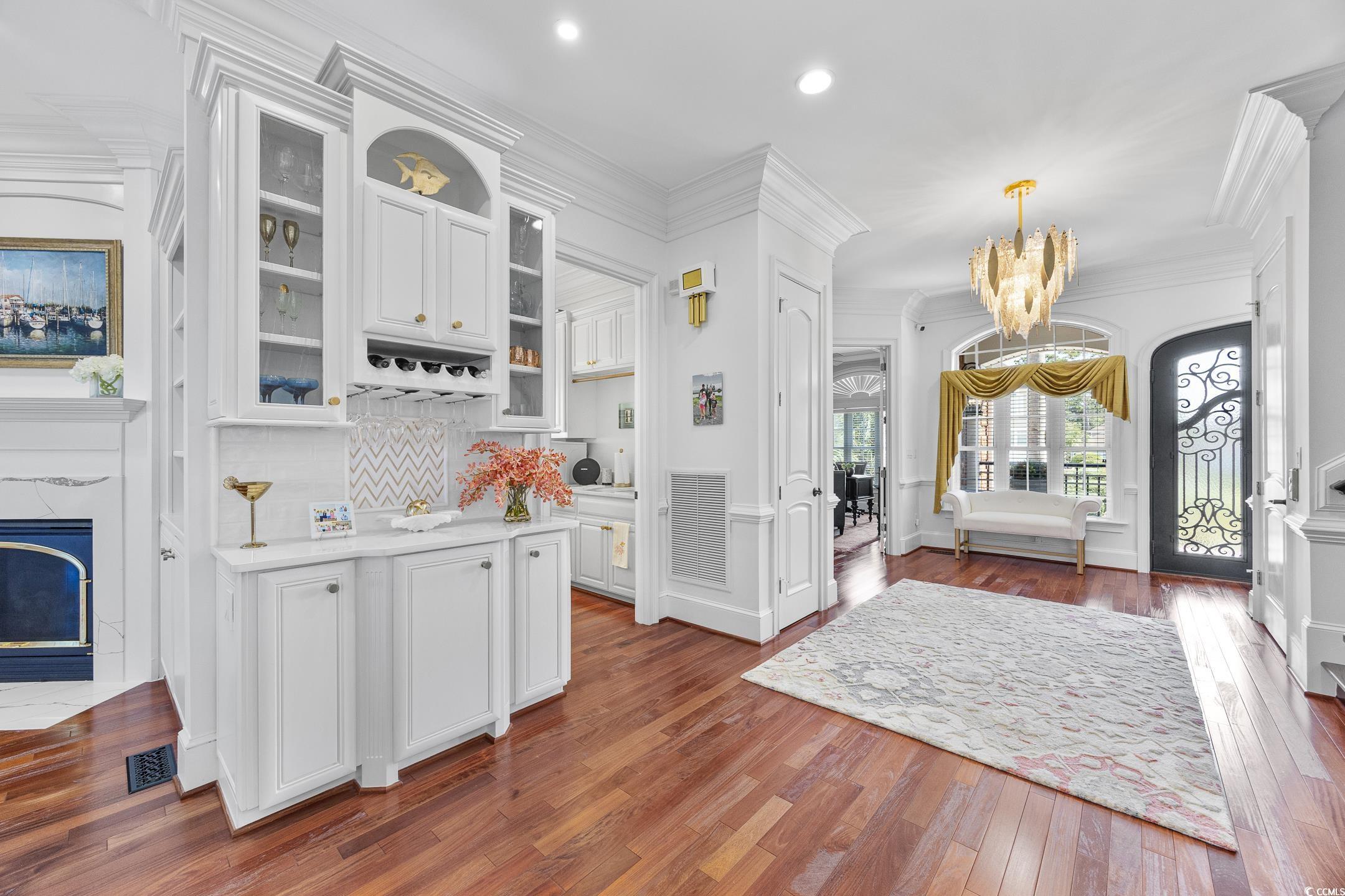 Image 2: Bar featuring glass insert cabinets, ornamental mo
