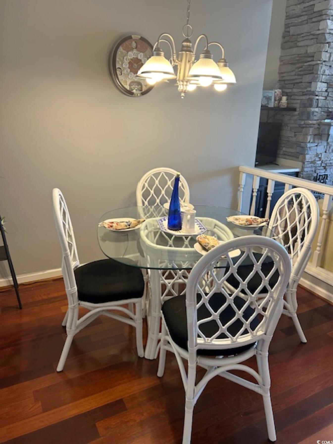 Image 4: Dining space with a notable chandelier, baseboards