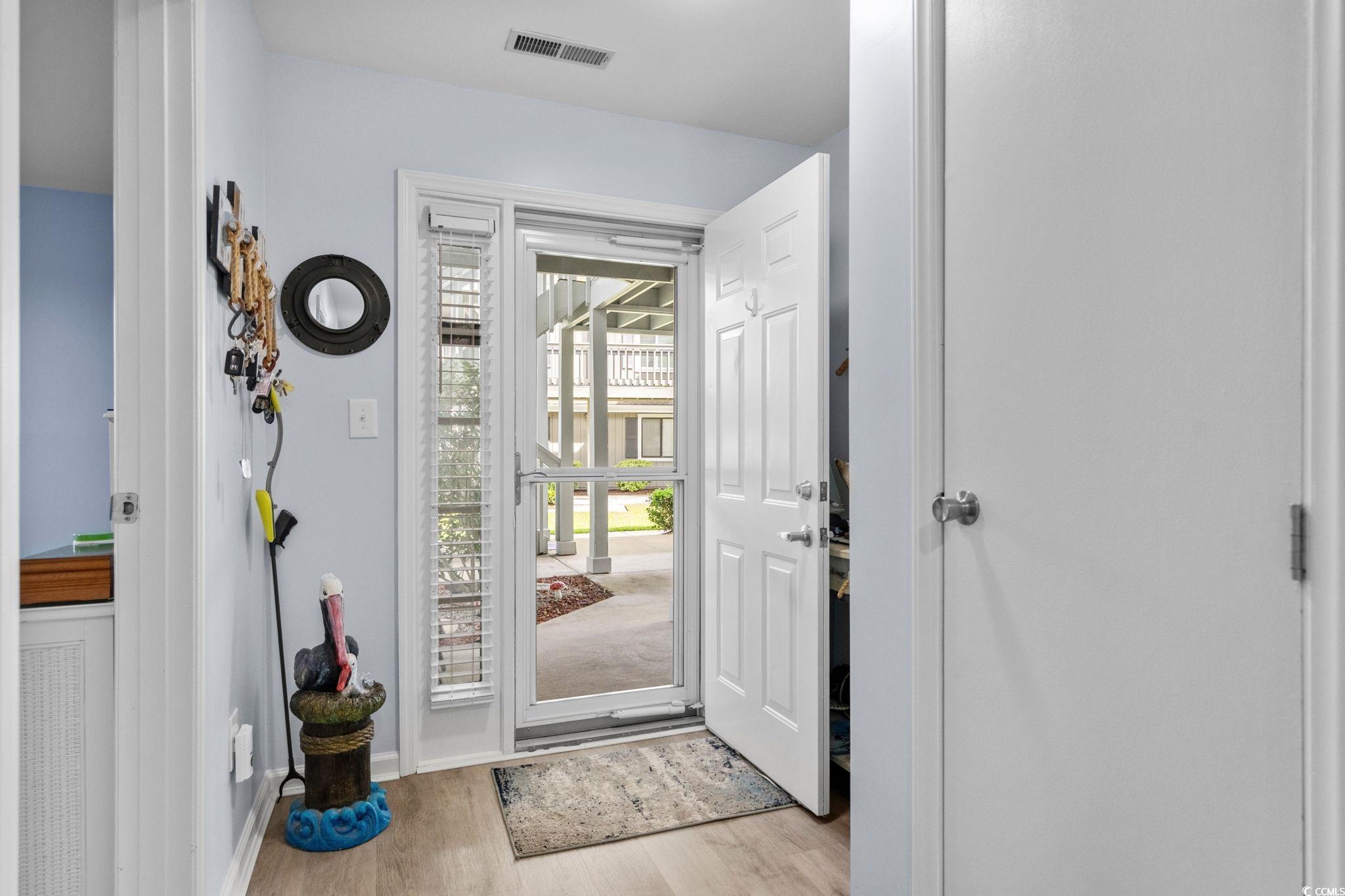 Image 2: Entryway with light wood-style floors and baseboar Image 2: Entryway with light wood-style floors and baseboar
