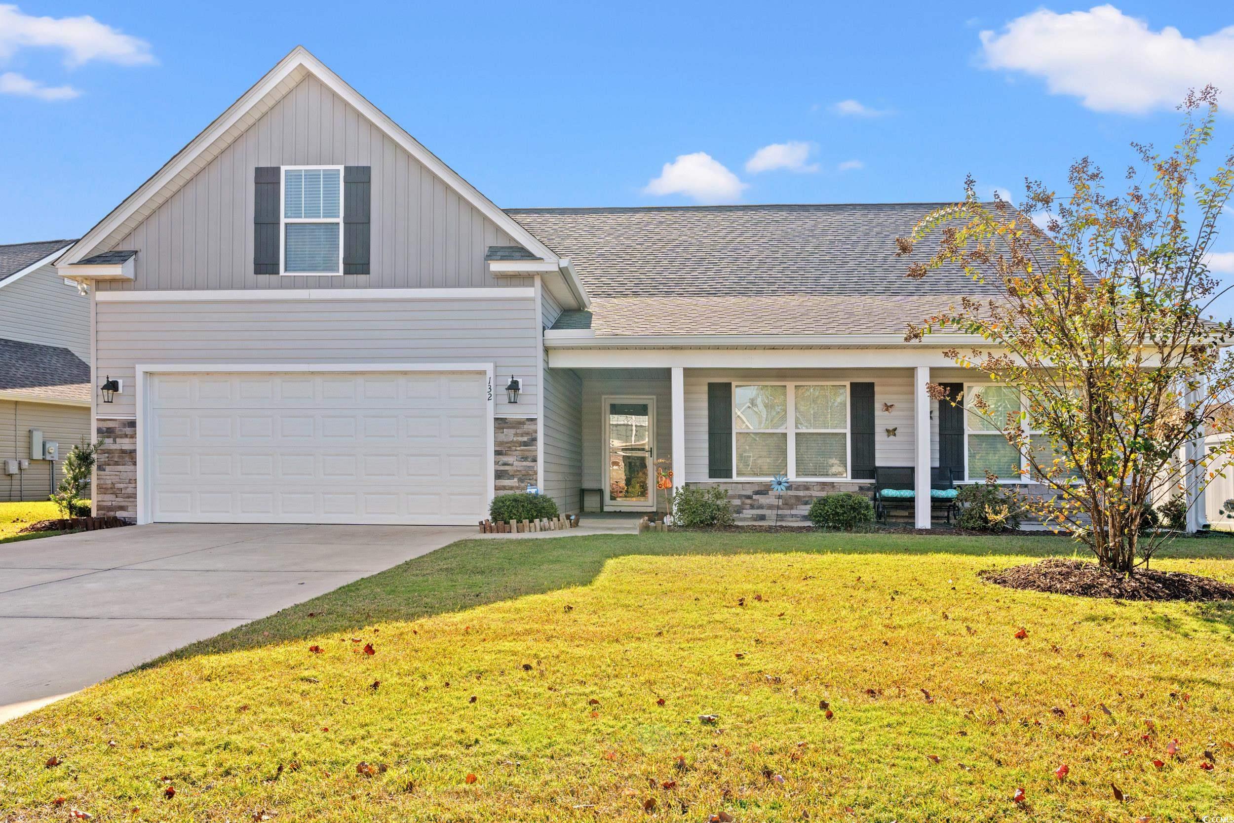 Image 1: View of front of home featuring covered porch, a f Image 1: View of front of home featuring covered porch, a f