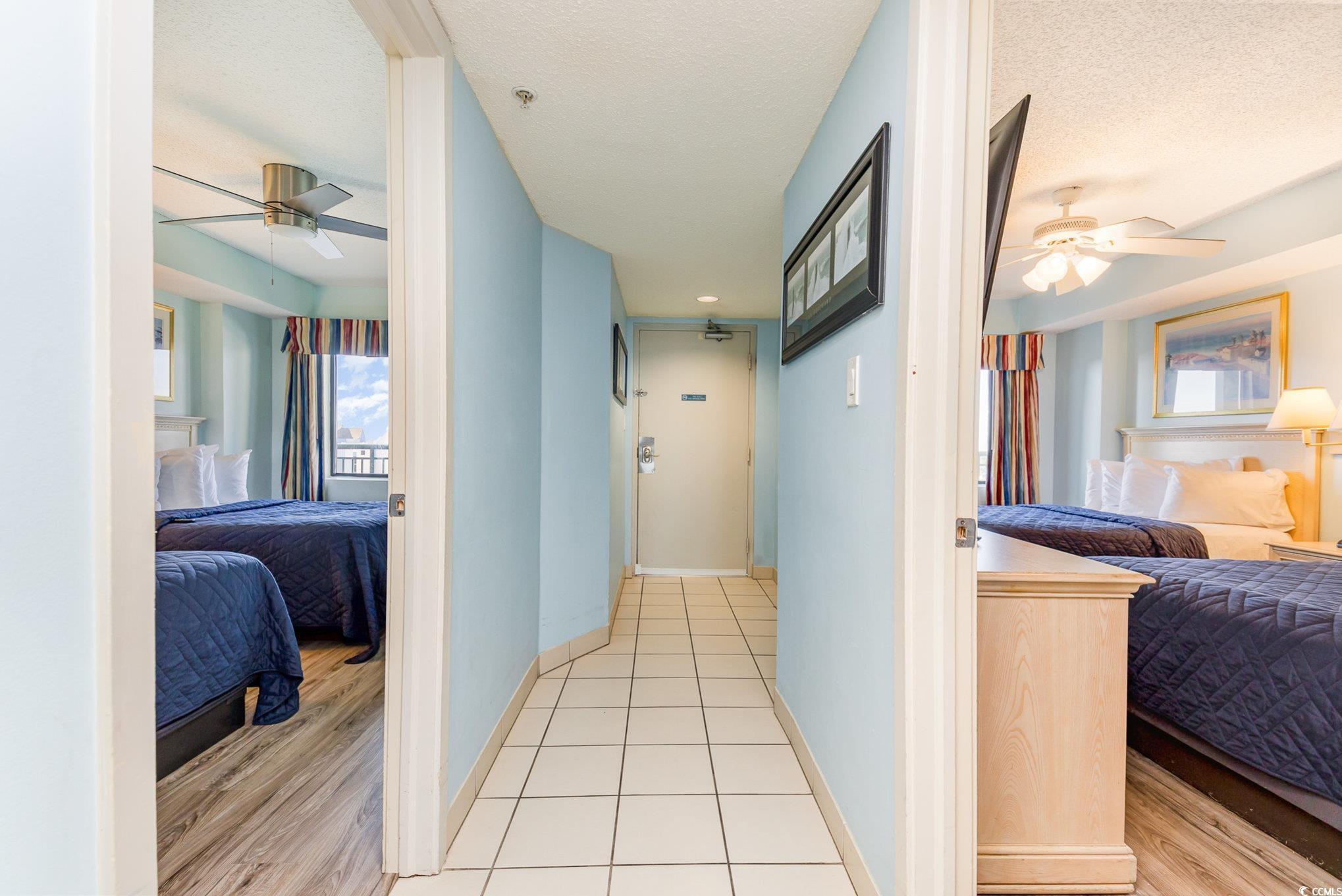 Image 4: Hall with a textured ceiling and light tile patter Image 4: Hall with a textured ceiling and light tile patter