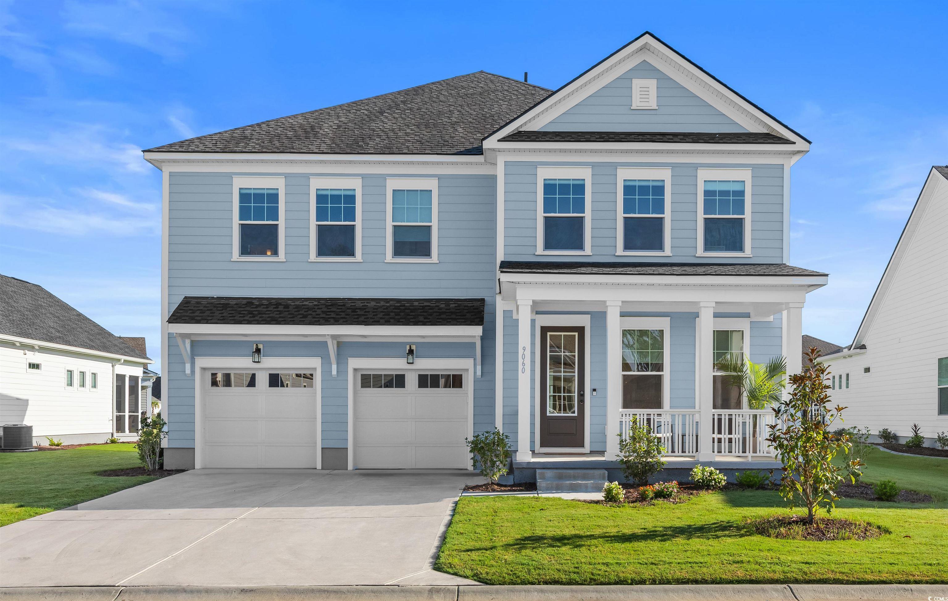 Image 1: View of front of property with a front lawn, a por