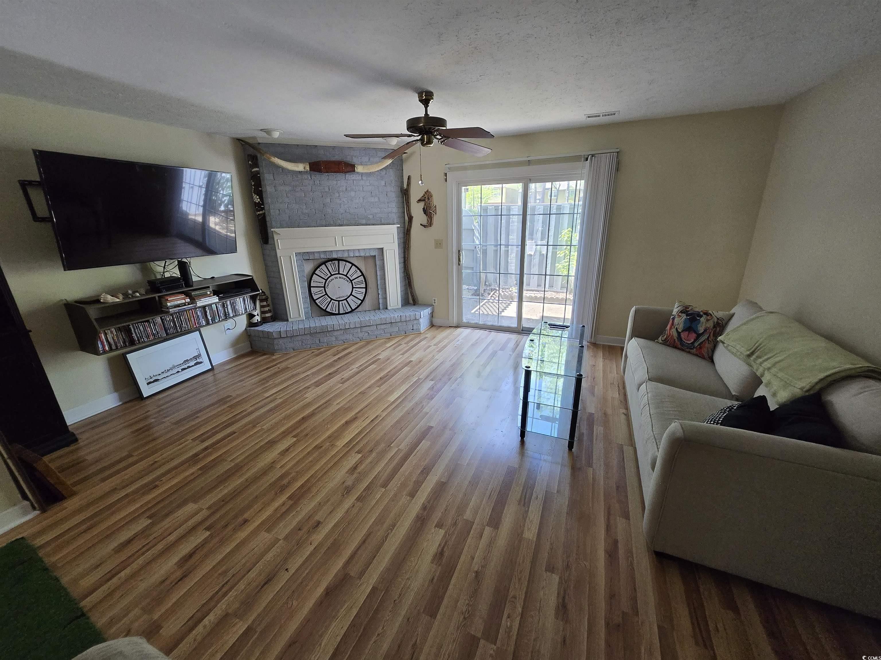 Image 2: Living room with wood finished floors, a textured Image 2: Living room with wood finished floors, a textured