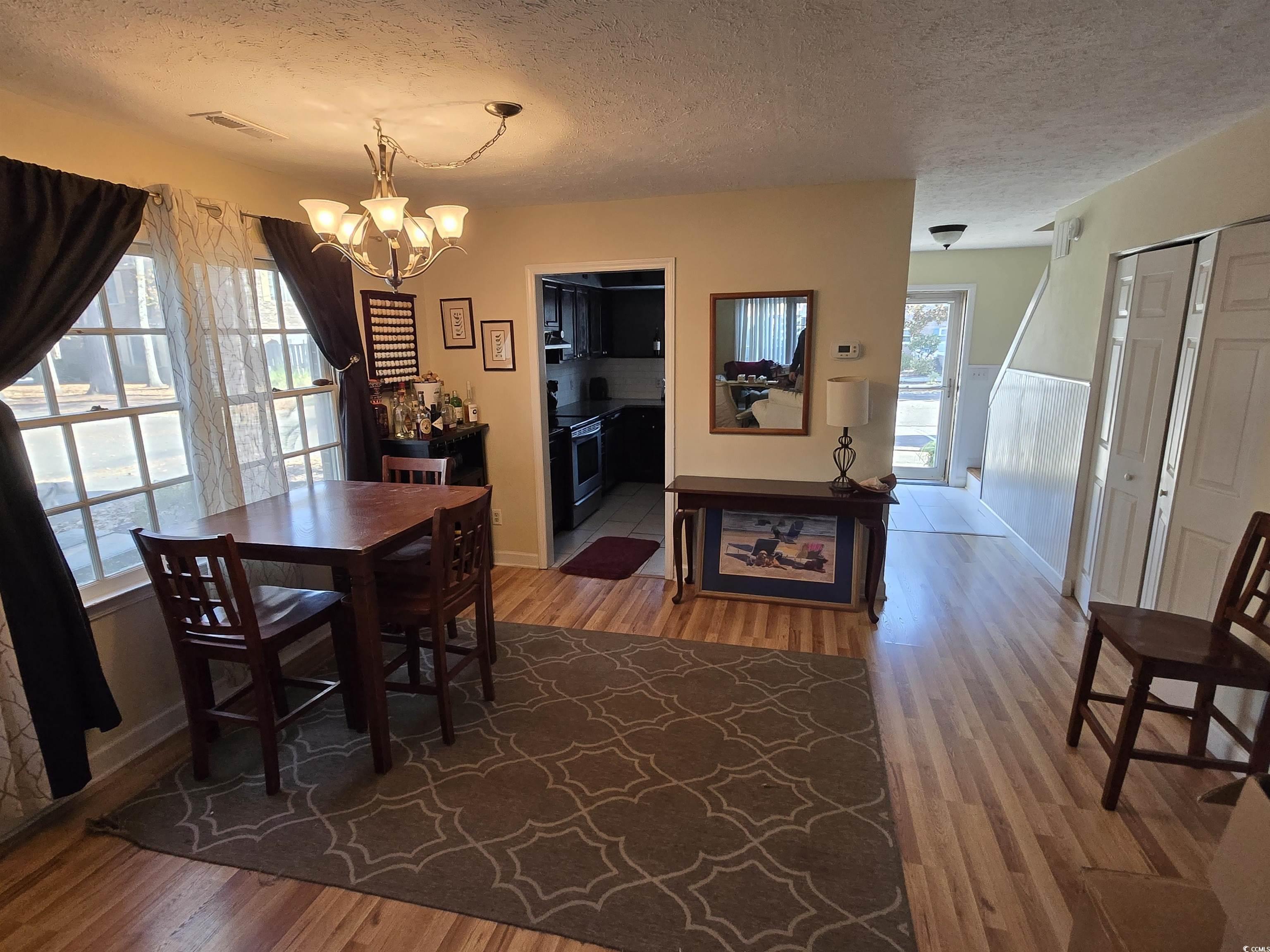 Image 3: Dining space featuring a textured ceiling, light w Image 3: Dining space featuring a textured ceiling, light w