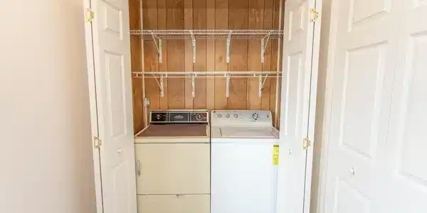 Image 3: Laundry room featuring washing machine and clothes