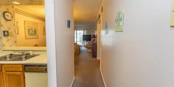Image 4: Corridor with a sink, baseboards, wallpapered wall