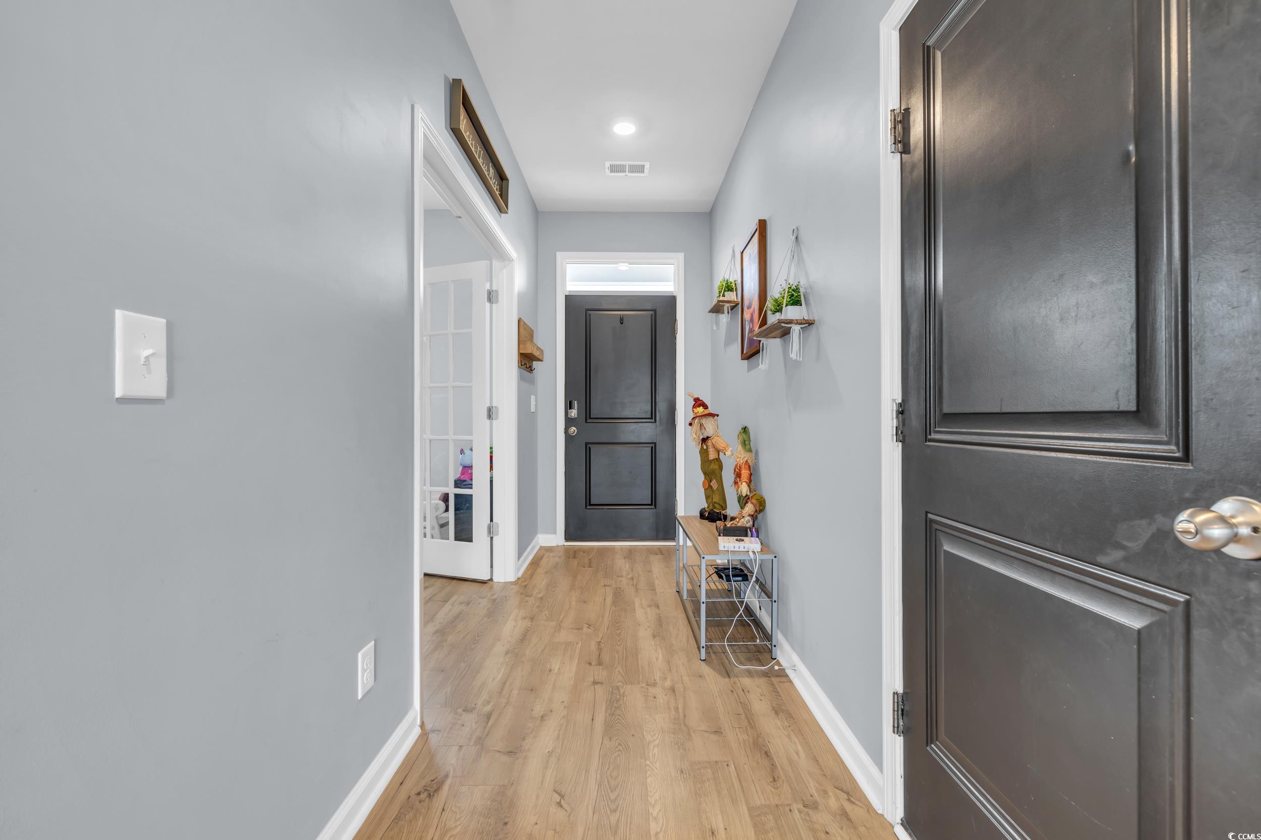 Image 3: Corridor with baseboards and light wood-type floor