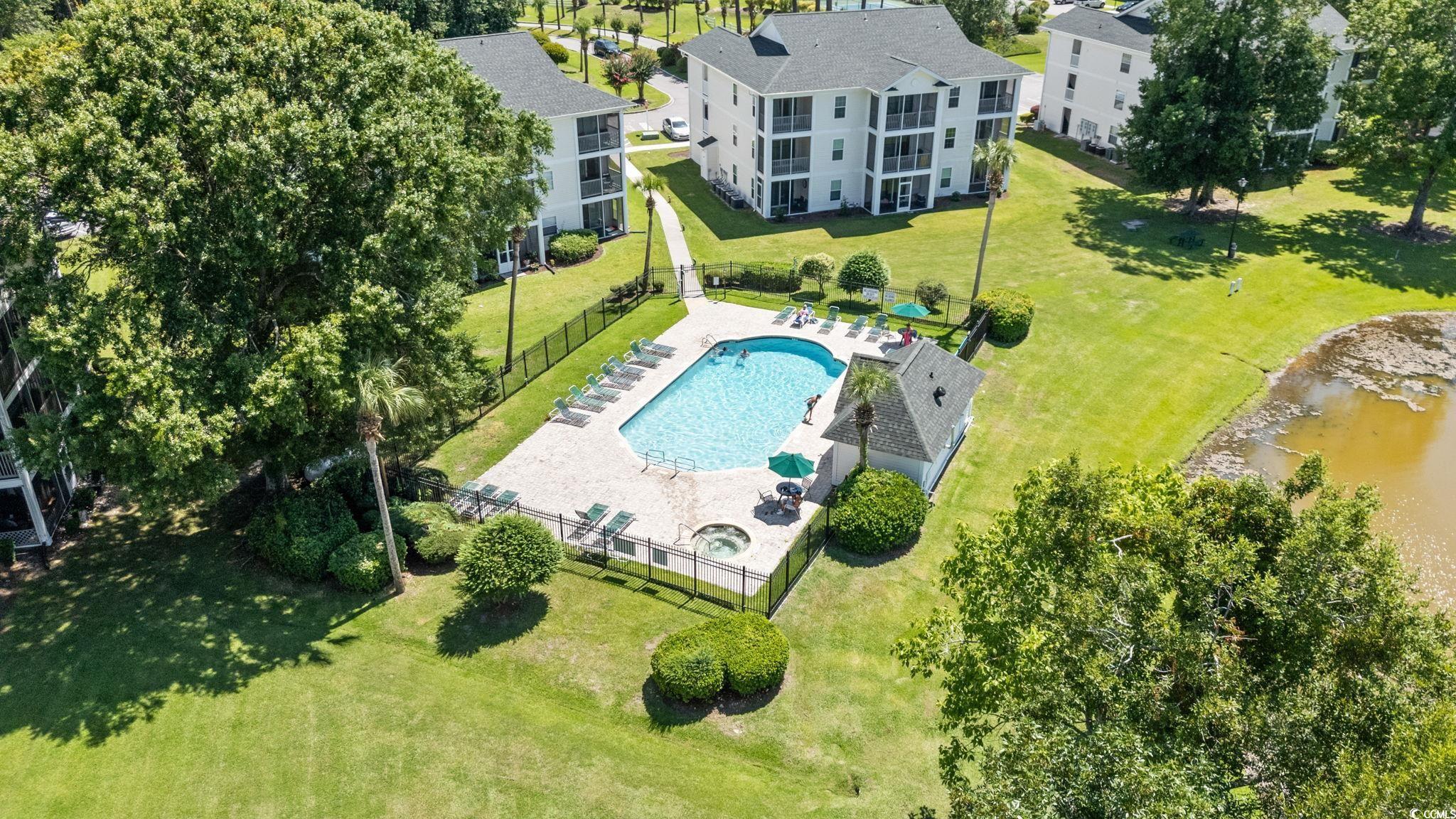 Image 3: Drone / aerial view of a pool area and a large bod