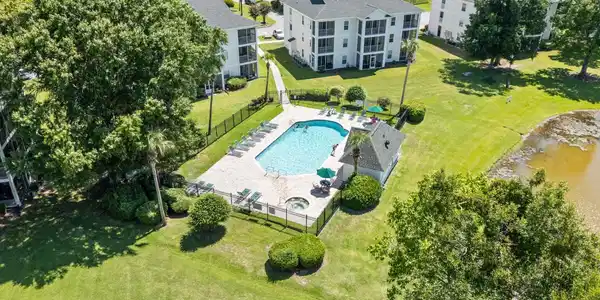 Image 3: Drone / aerial view of a pool area and a large bod