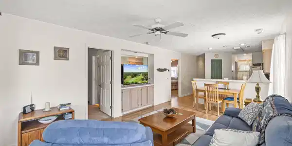 Image 4: Living area with light wood-style floors, a ceilin