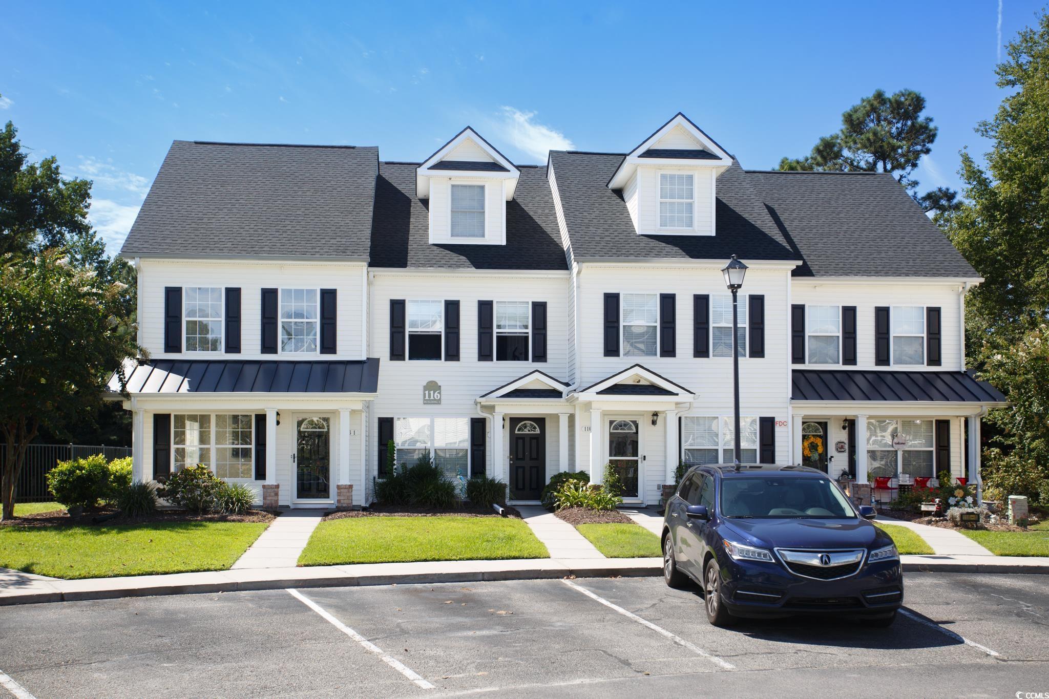 Image 2: View of front of home featuring a standing seam ro