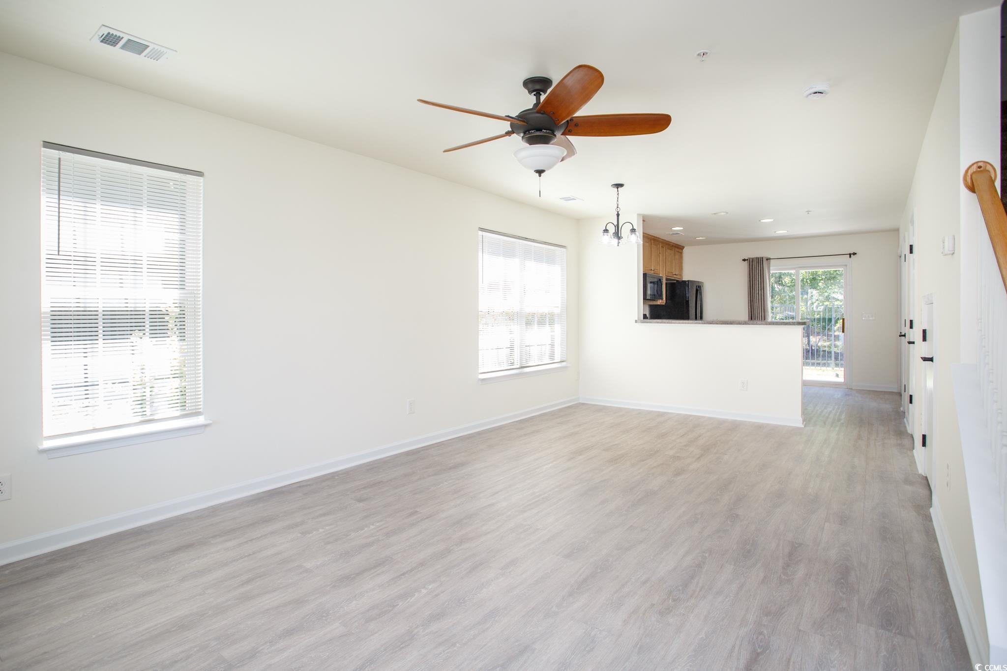 Image 3: Unfurnished living room with light wood finished f