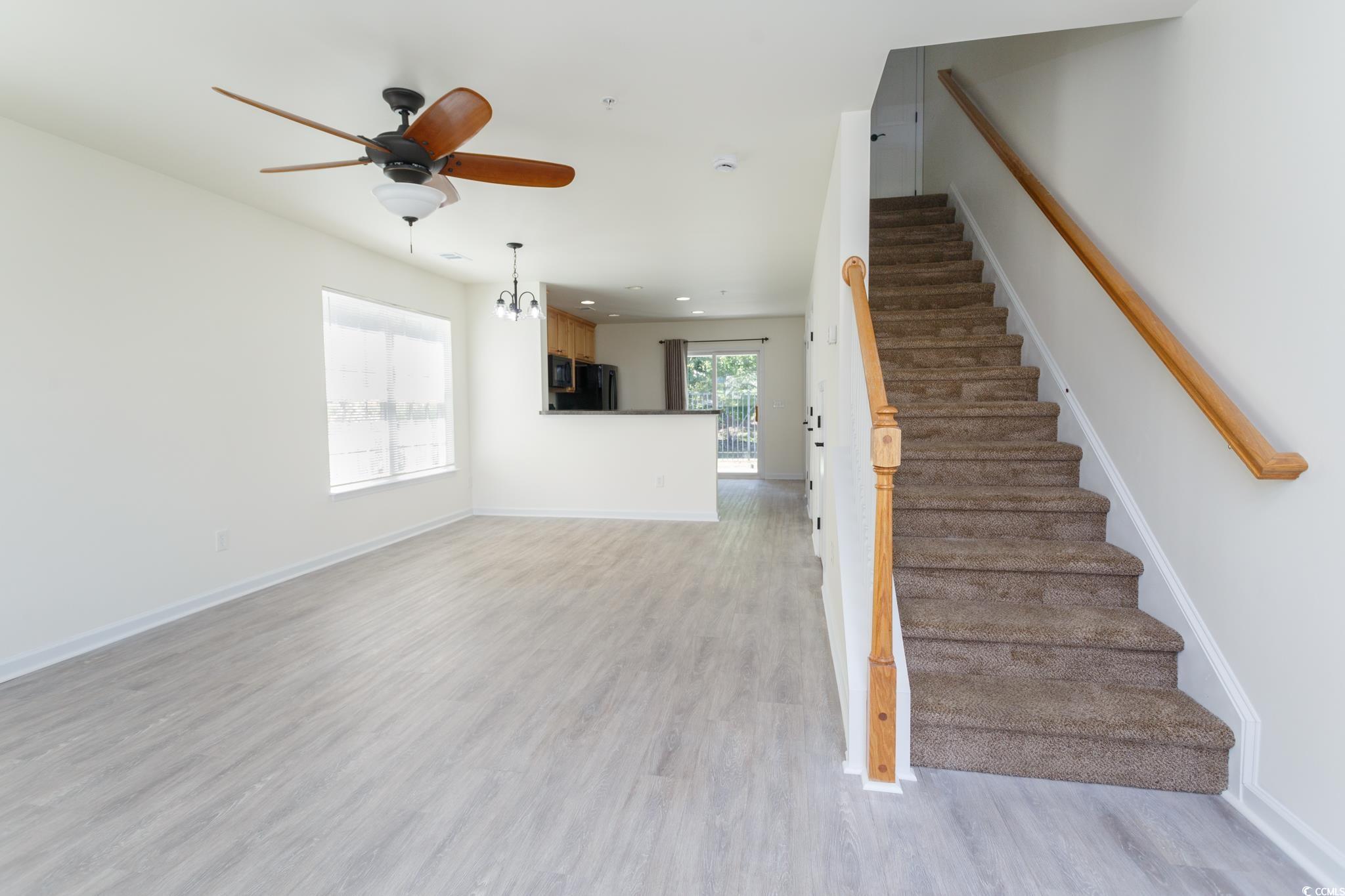 Image 4: Stairway featuring wood finished floors, ceiling f
