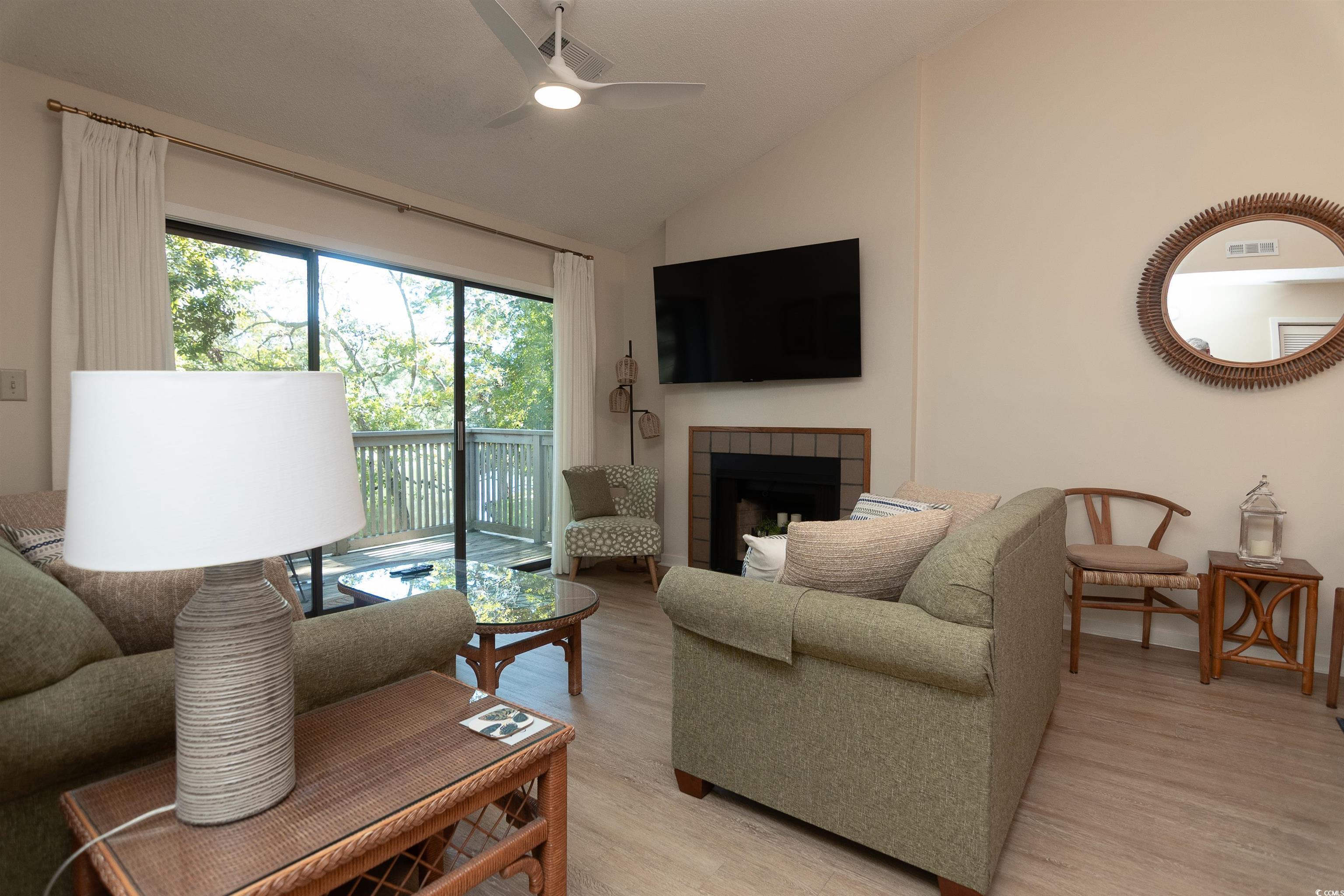 Image 4: Living area with lofted ceiling, a tiled fireplace Image 4: Living area with lofted ceiling, a tiled fireplace