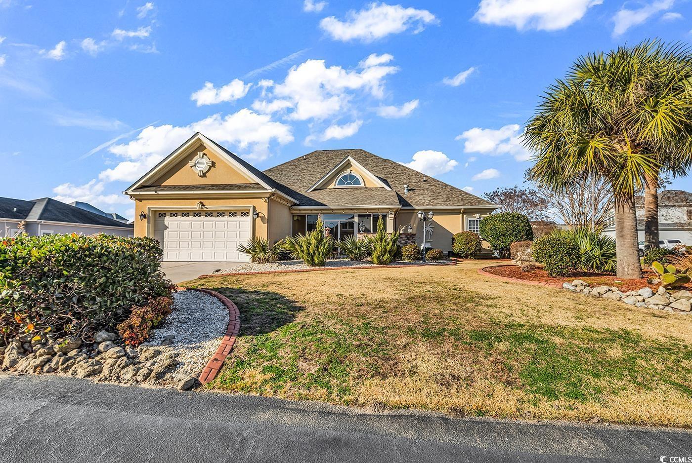 Image 2: View of front of home featuring stucco siding, dri