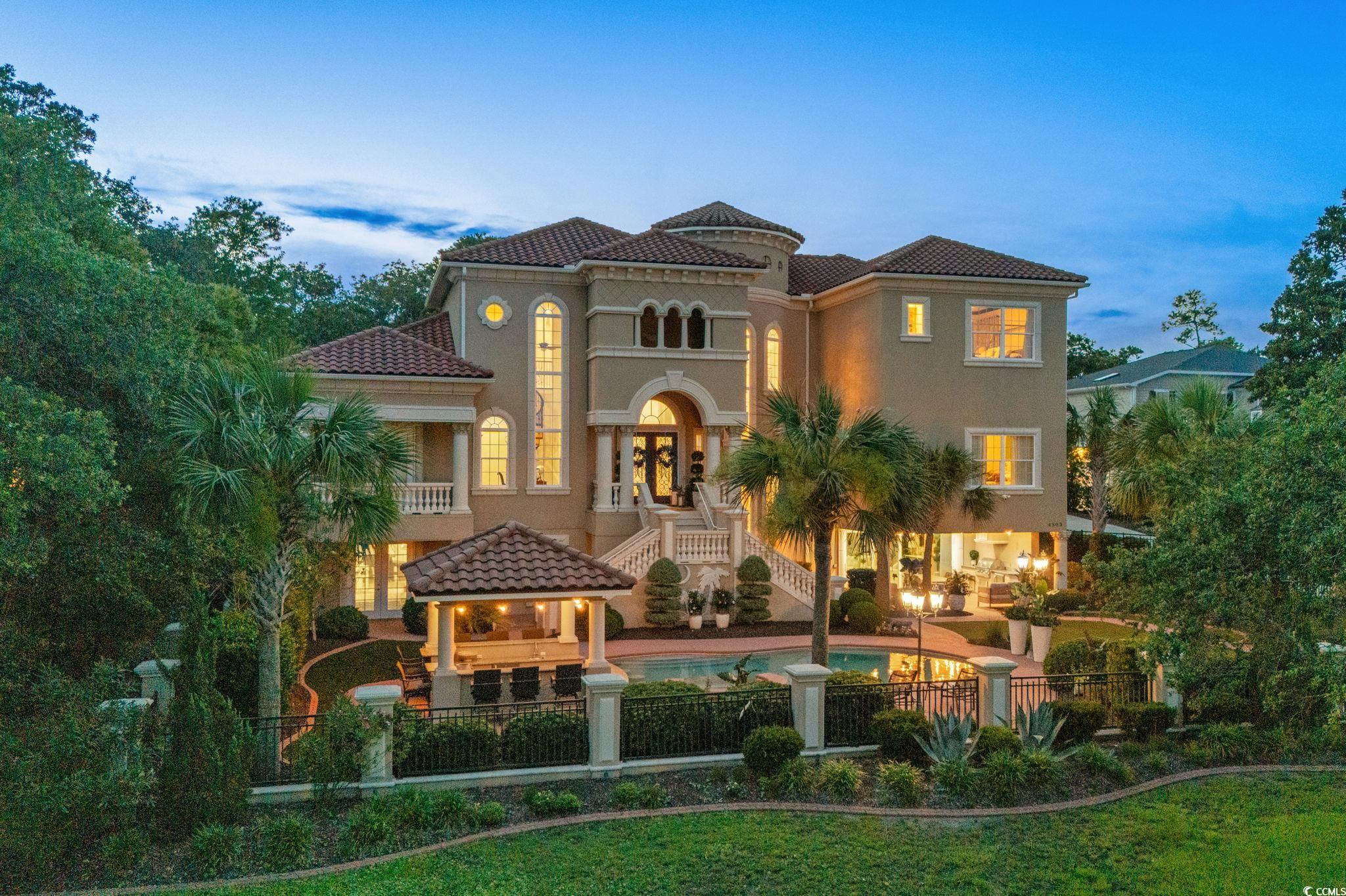 Image 1: View of front of property featuring a tile roof, s