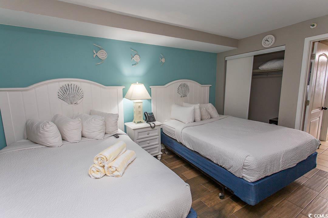 Image 3: Bedroom featuring wood finished floors and a close