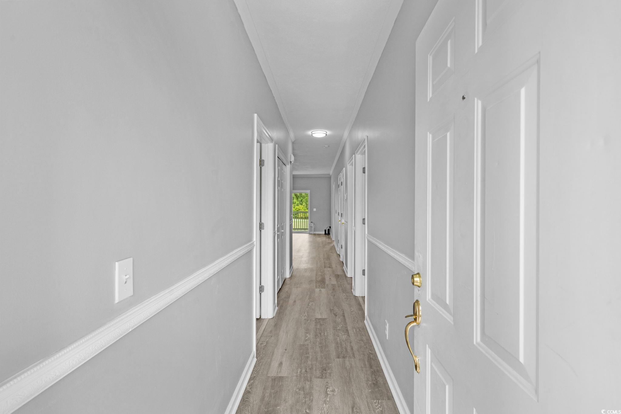 Image 2: Hallway featuring light wood-type flooring and bas