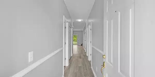 Image 2: Hallway featuring light wood-type flooring and bas