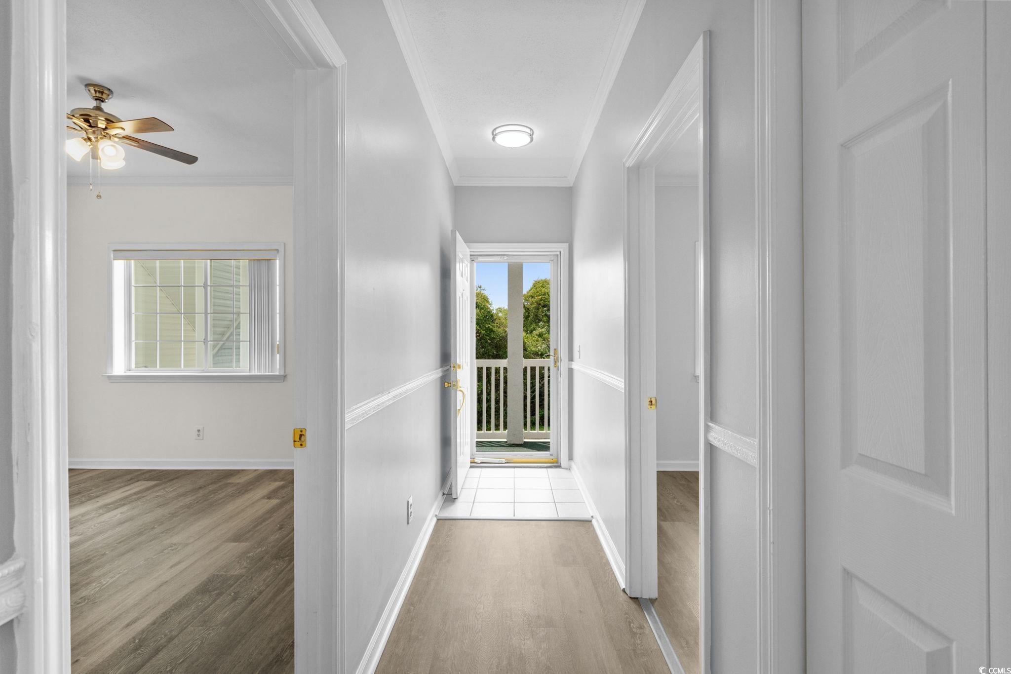 Image 3: Hallway with wood finished floors and ornamental m