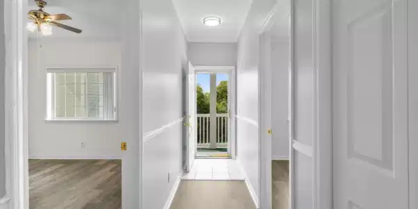 Image 3: Hallway with wood finished floors and ornamental m