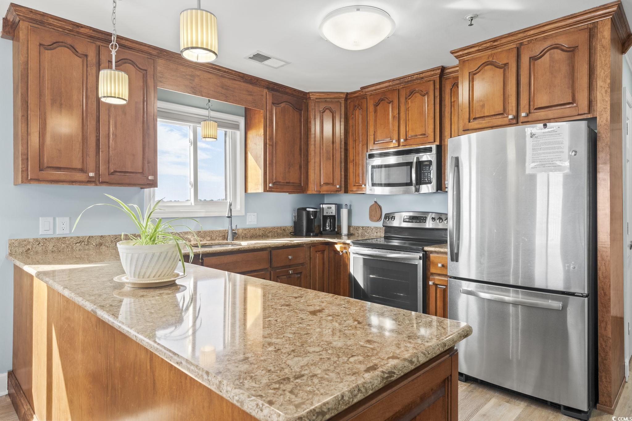 Image 4: Kitchen with custom cabinets, granite countertops,
