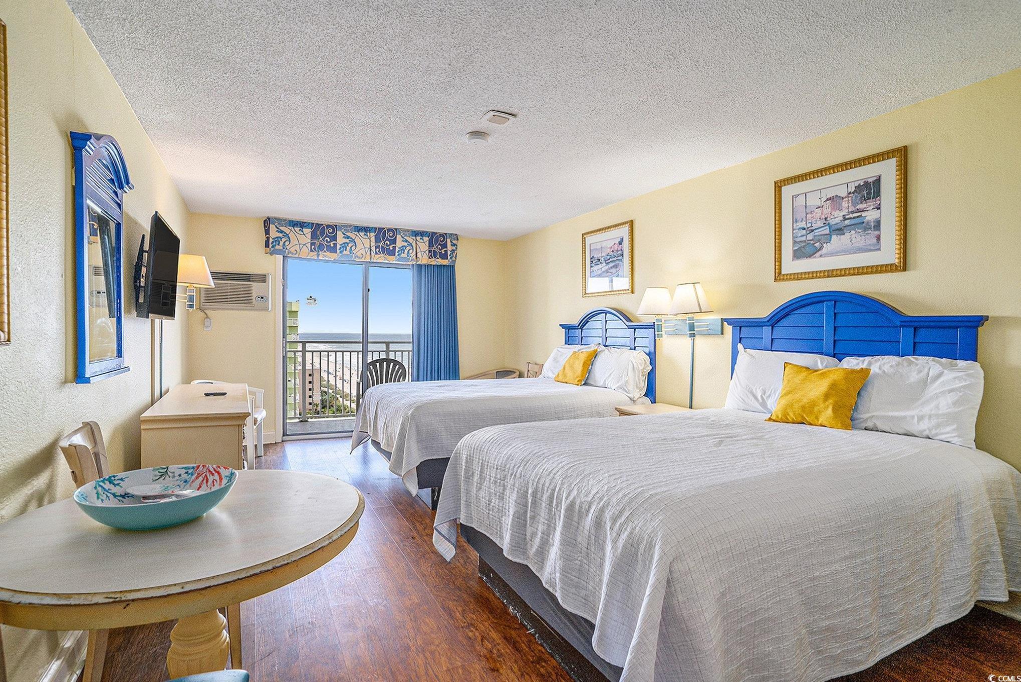 Image 2: Bedroom with access to outside, a textured ceiling Image 2: Bedroom with access to outside, a textured ceiling